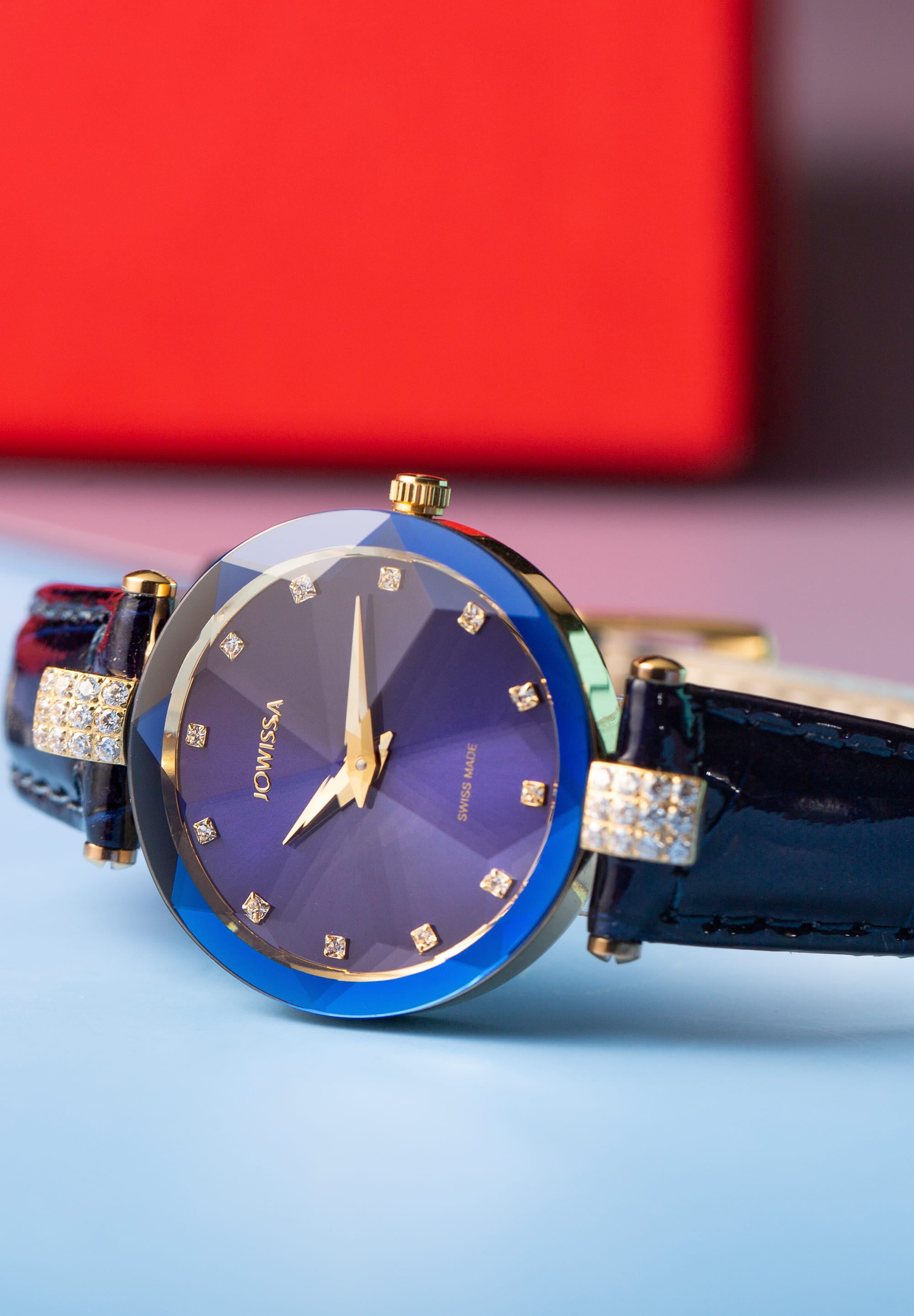 Facet Strass Swiss Ladies Watch J5.617.M featuring a blue sunray dial, Strass stones, and a crocodile leather strap, showcasing luxury and elegance.