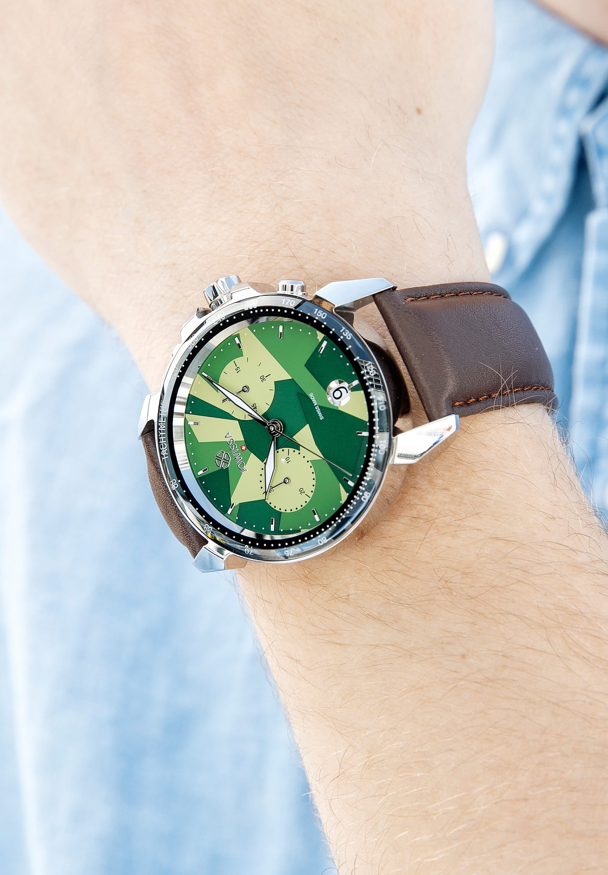 LeWy 15 Swiss Men's Watch J7.111.L featuring a green camouflage dial, stainless steel case, and brown leather strap.