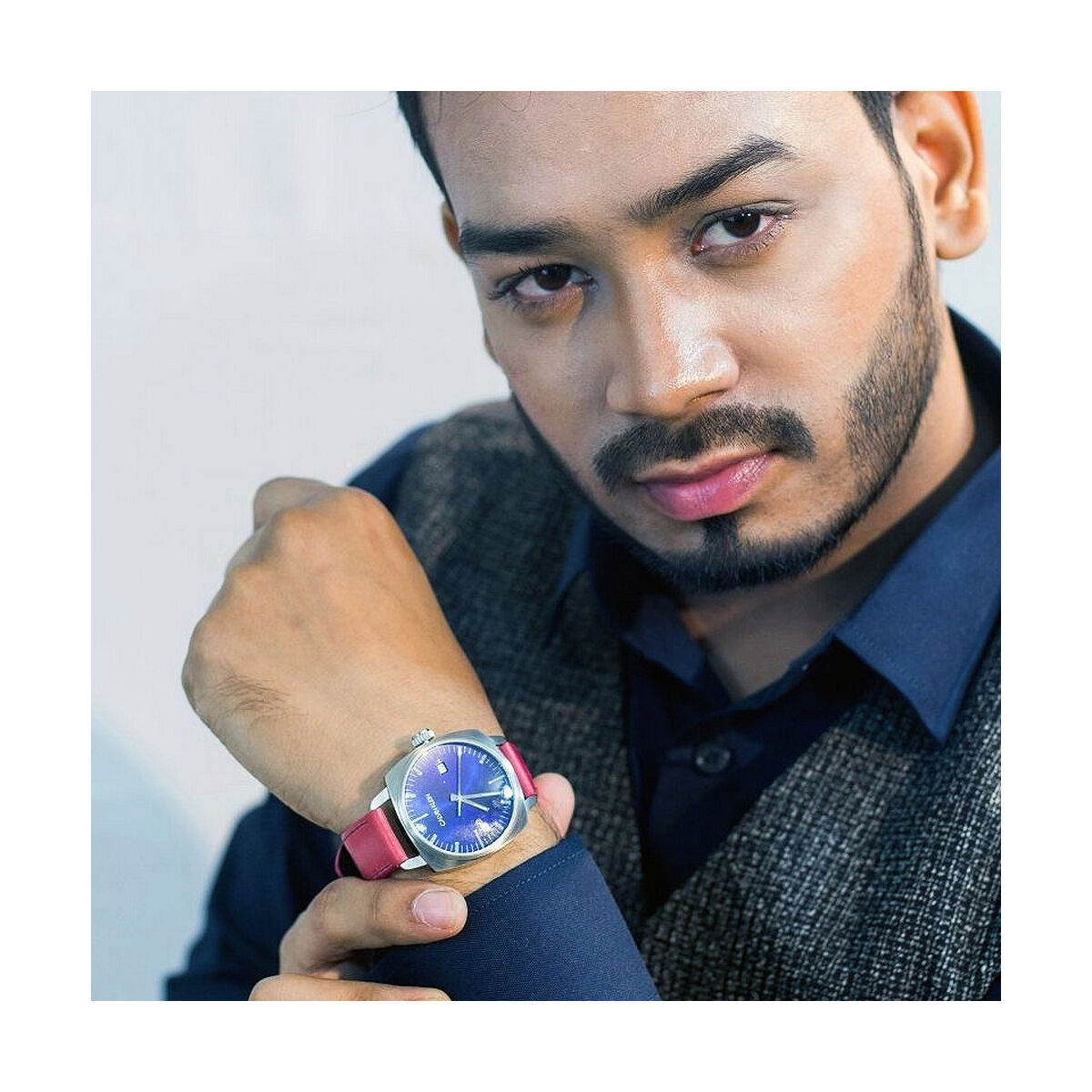 Man showing a wristwatch.