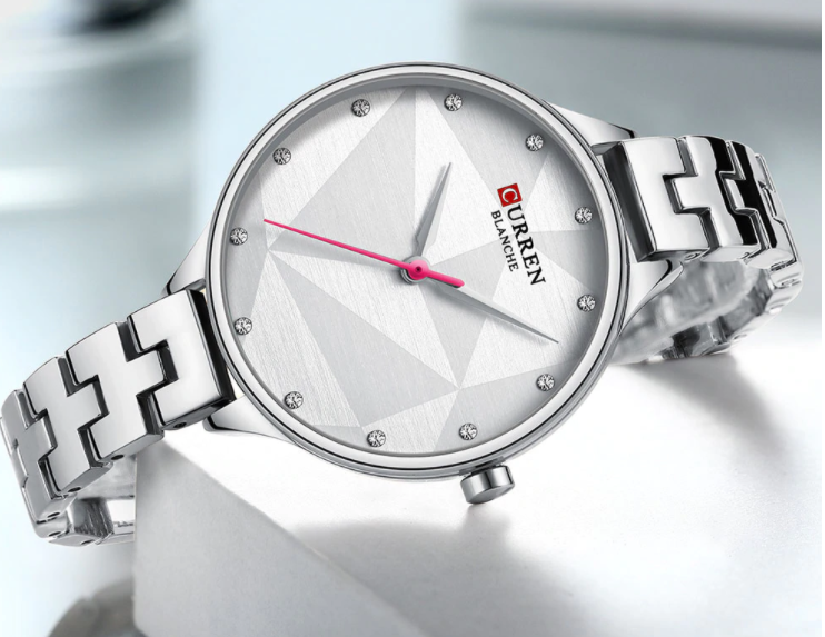 Scarlet Curren Women Watch featuring a round dial and sleek metal band, showcasing elegance and durability.