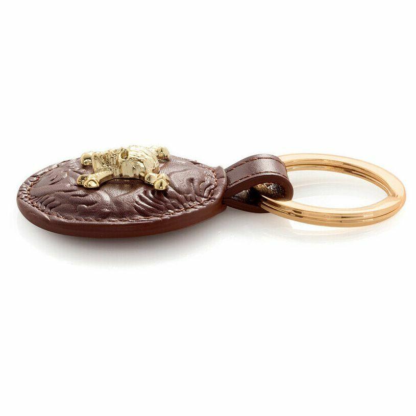 S.T. Dupont Pirates of the Caribbean embossed brown cowhide leather key ring featuring a gold skull and crossbones design.