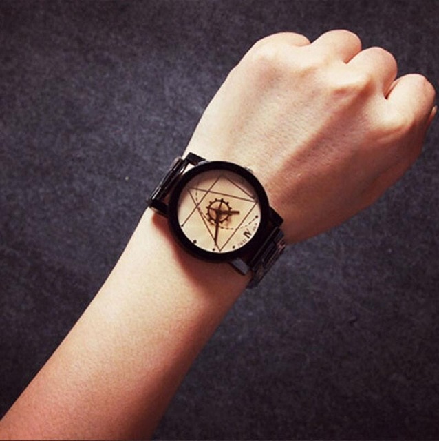 Hand wearing an artistic watch.