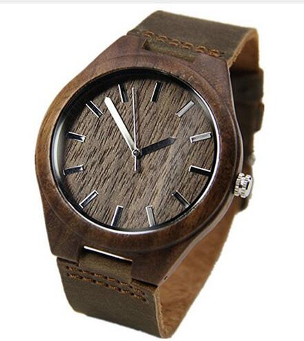 Walnut wooden wrist watch featuring a round dial and leather strap, showcasing its elegant design and craftsmanship.