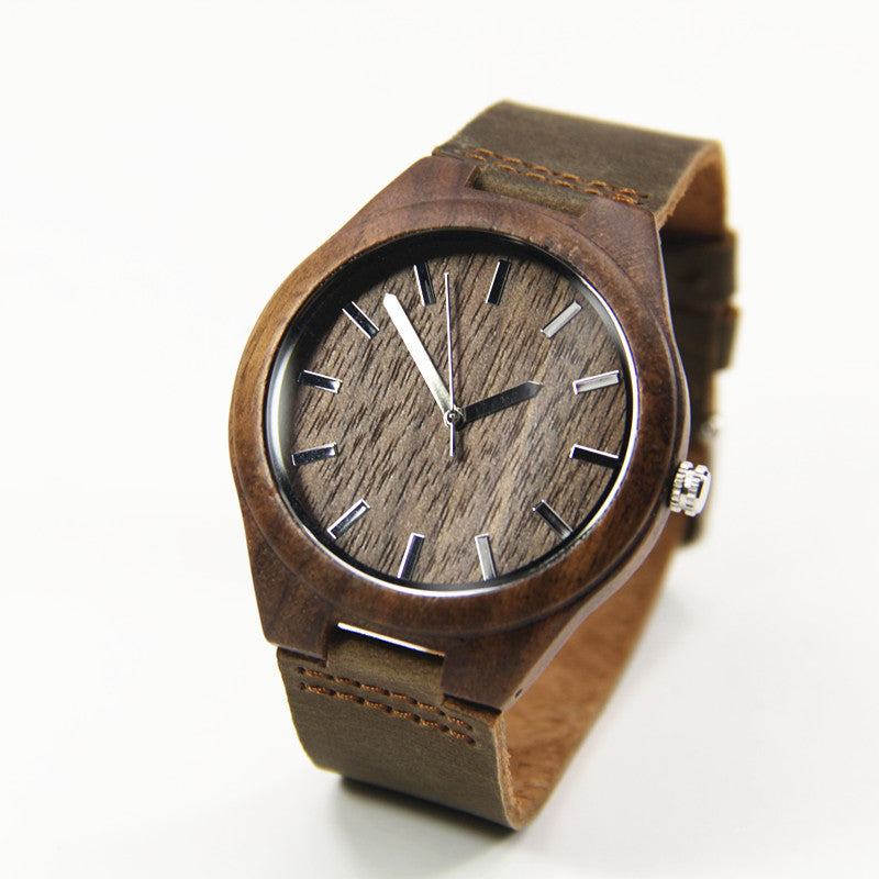 Walnut wooden wrist watch featuring a round dial and leather strap, showcasing its elegant design and craftsmanship.