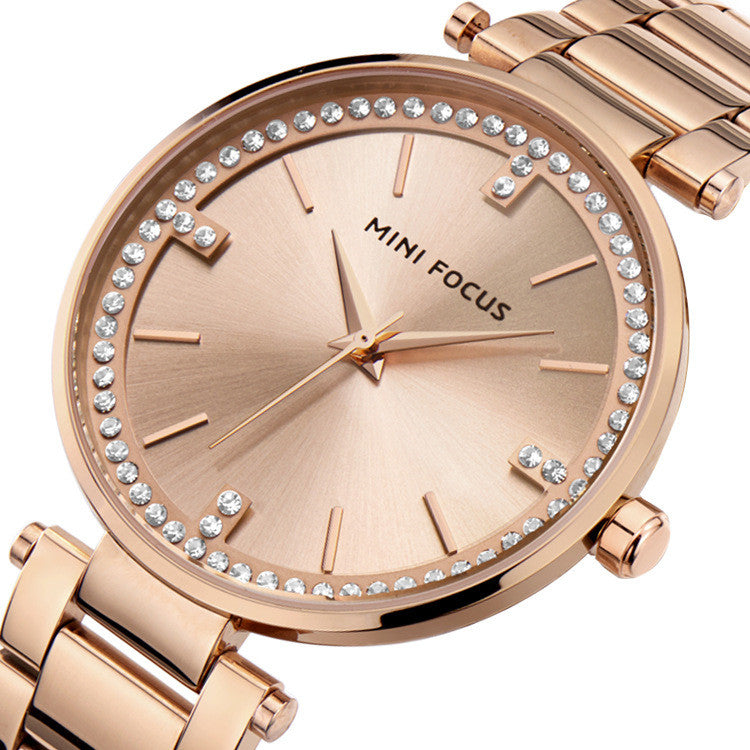 A stylish Women's Quartz Diamond Movement Calendar Waterproof Watch featuring a round dial, stainless steel strap, and diamond accents.