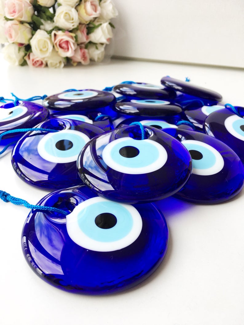 A 7cm handmade blue glass evil eye bead featuring intricate designs, symbolizing protection and good luck.