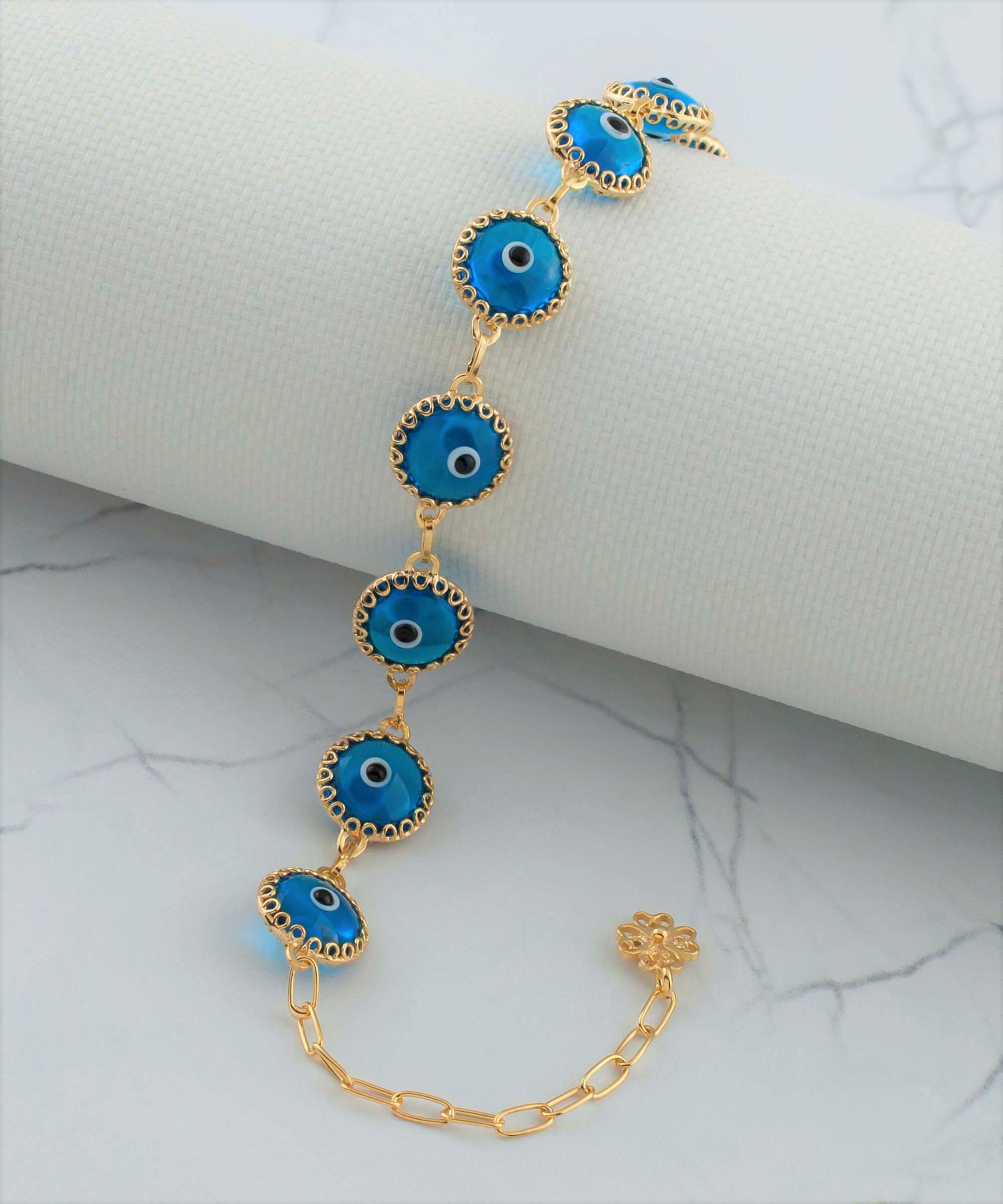 Gold plated sterling silver link bracelet featuring 10 lapis blue evil eye beads, elegantly designed with a lobster claw clasp.