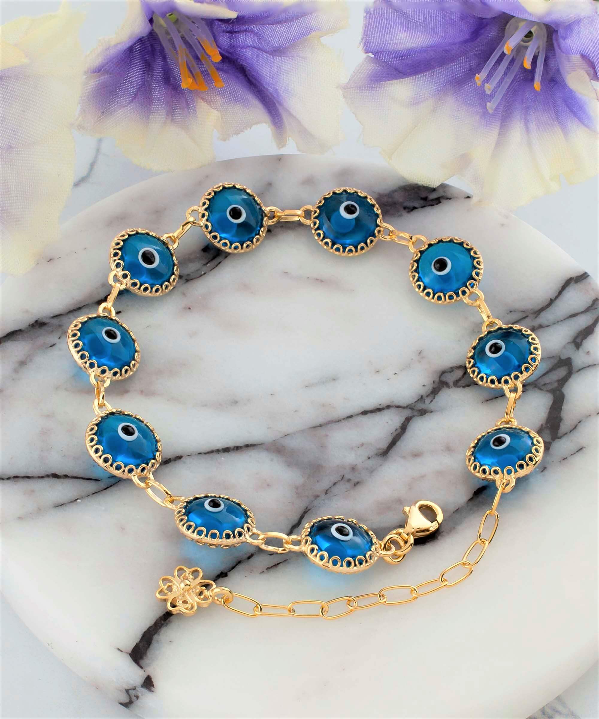 Gold plated sterling silver link bracelet featuring 10 lapis blue evil eye beads, elegantly designed with a lobster claw clasp.