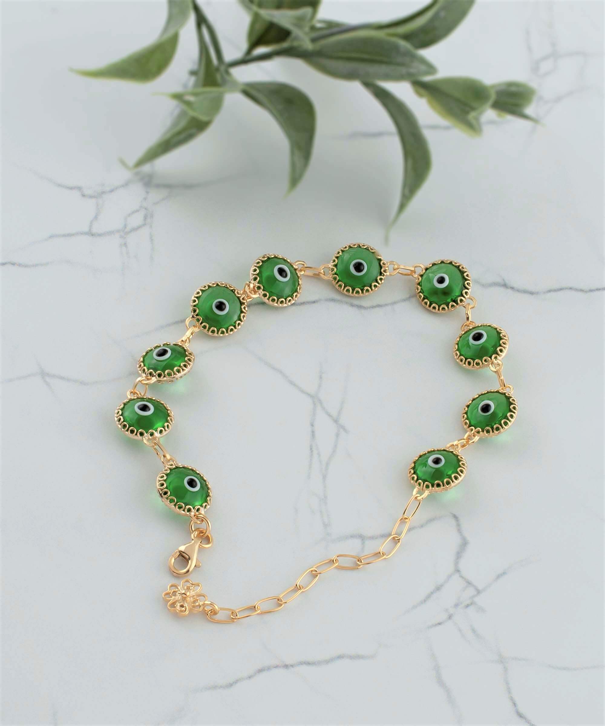 Mint green evil eye bracelet made of gold plated sterling silver with ten beads and a rolo chain design, secured with a lobster claw clasp.