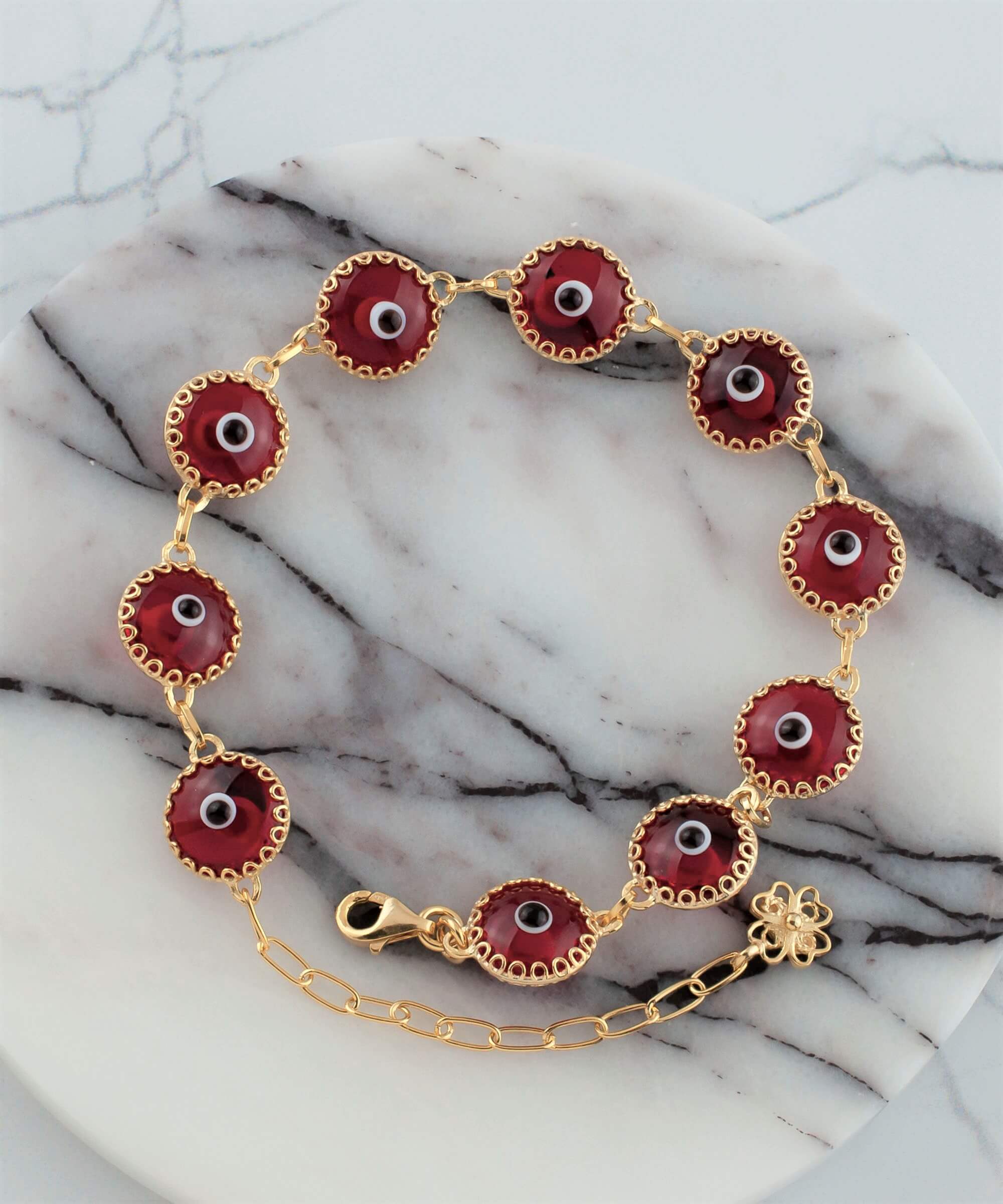 Gold plated sterling silver bracelet featuring 10 red evil eye beads, designed with a strong rolo chain and secured with a lobster claw clasp.