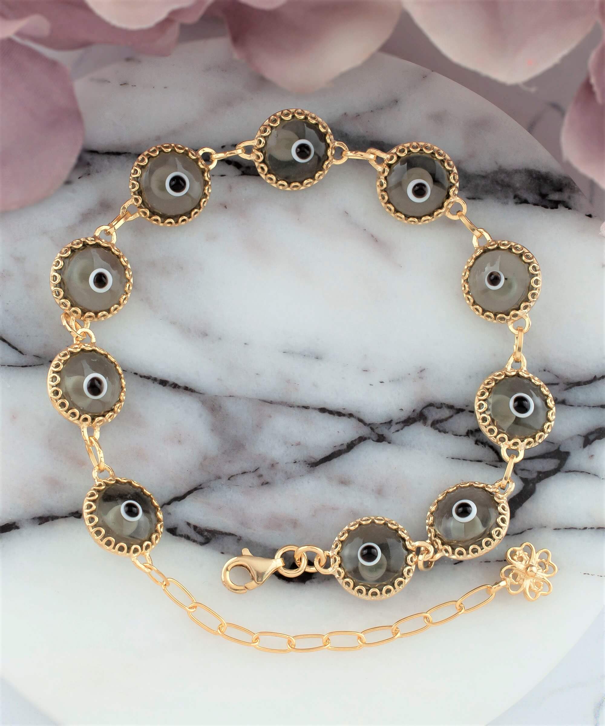 Elegant gold plated sterling silver link bracelet featuring 10 smokey evil eye beads, designed for women with a lobster claw clasp.