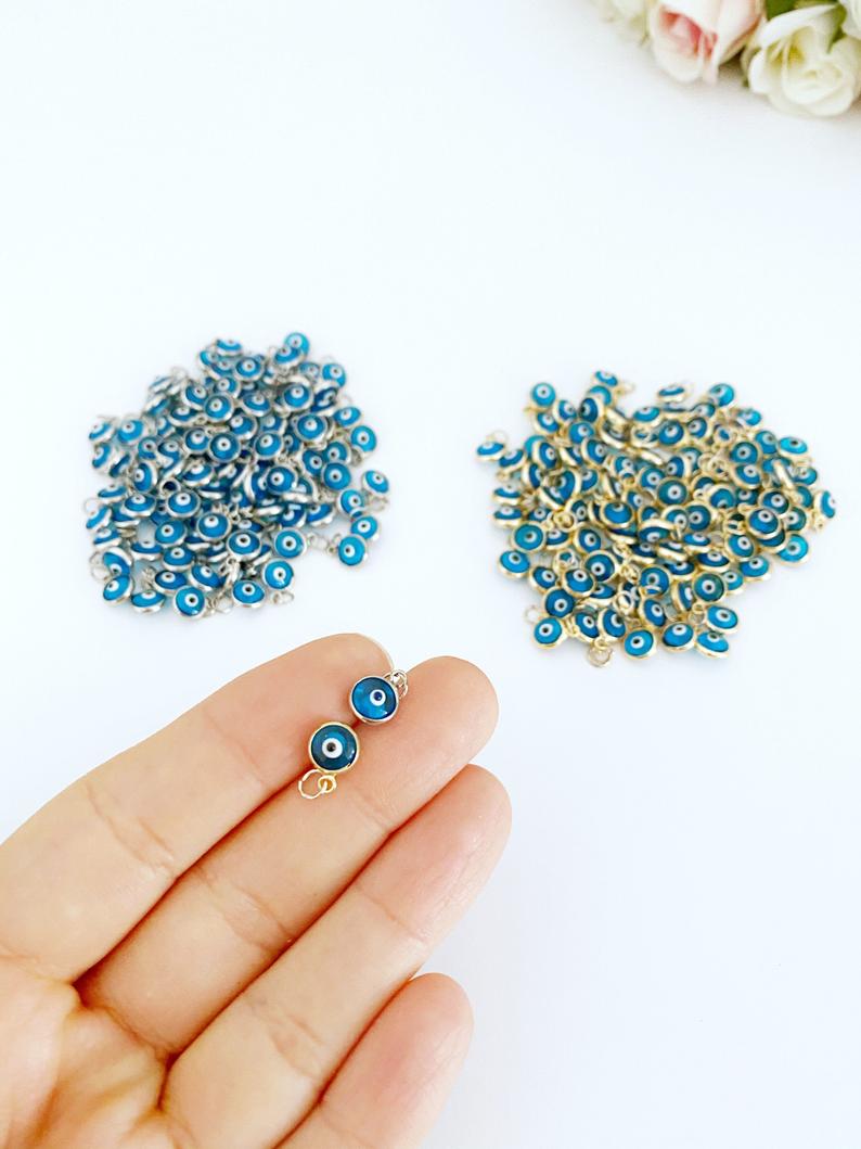 A collection of 100 turquoise evil eye beads, each 6mm in diameter, showcasing a double-sided charm design, perfect for DIY jewelry making.