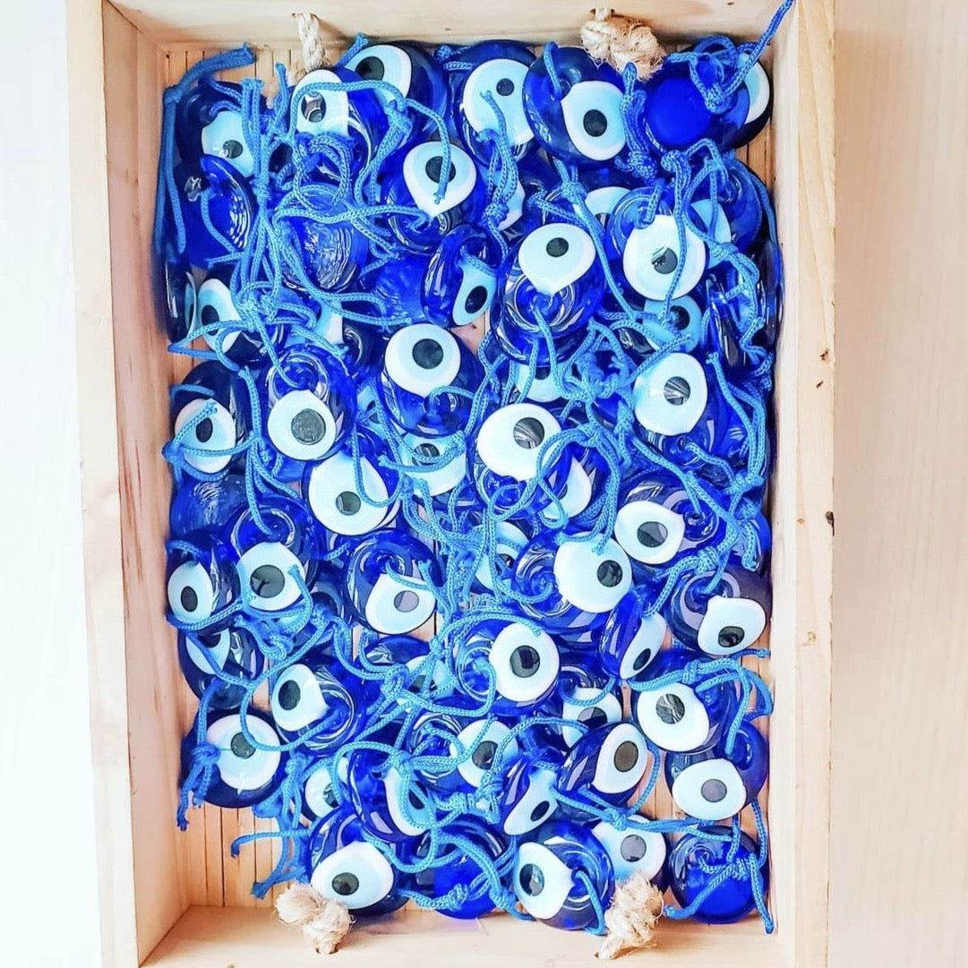 A collection of 100 unique handmade evil eye beads, each 3.5cm, featuring a blue rope for hanging, symbolizing protection and good luck.