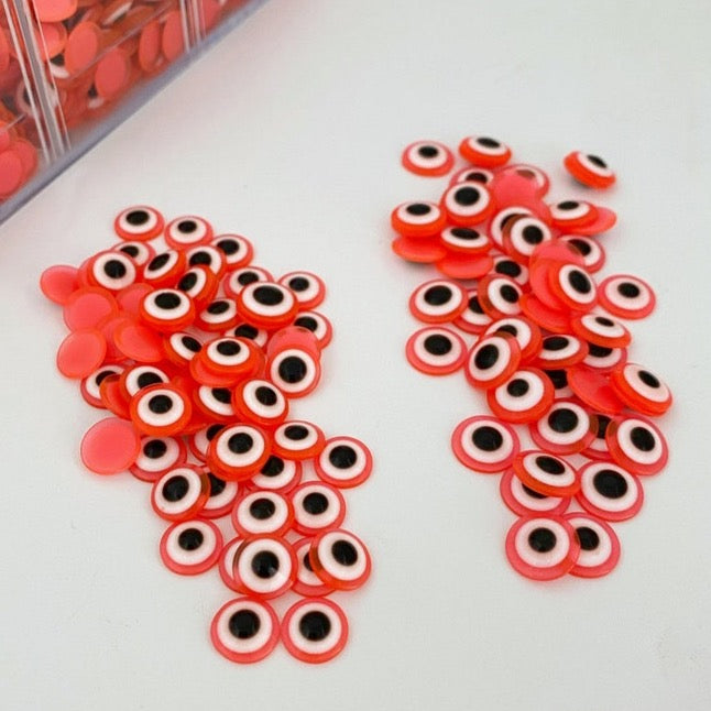 100 pcs of orange Evil Eye Cabochons in 8mm and 10mm sizes, perfect for DIY jewelry and crafts.