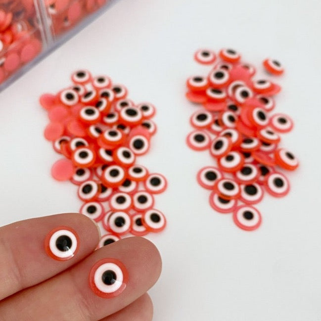 100 pcs of orange Evil Eye Cabochons in 8mm and 10mm sizes, perfect for DIY jewelry and crafts.