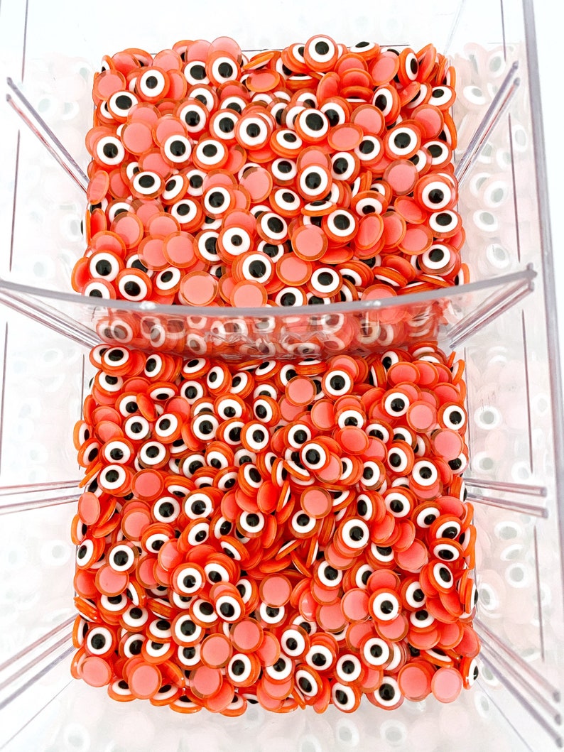 100 pcs of orange Evil Eye Cabochons in 8mm and 10mm sizes, perfect for DIY jewelry and crafts.