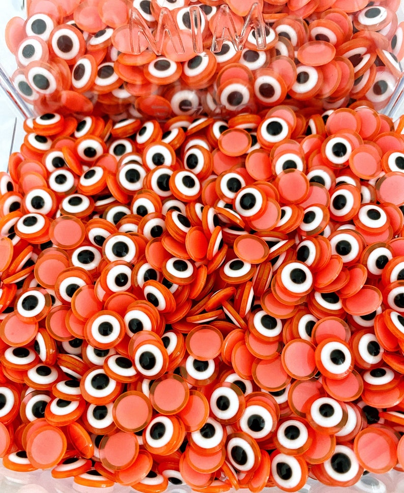 100 pcs of orange Evil Eye Cabochons in 8mm and 10mm sizes, perfect for DIY jewelry and crafts.