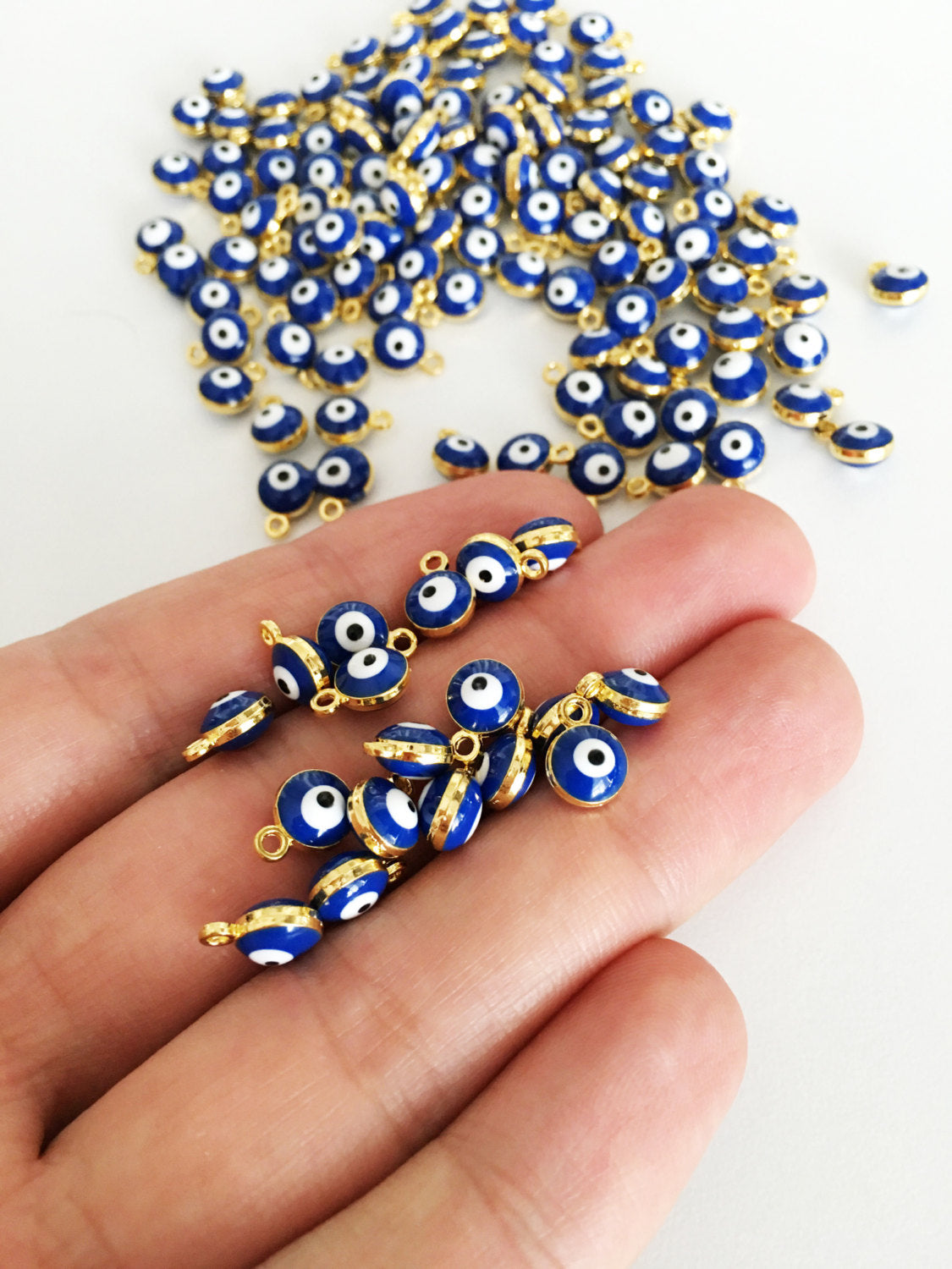 10 pcs gold plated evil eye charm set featuring blue Turkish evil eye beads, perfect for jewelry making.