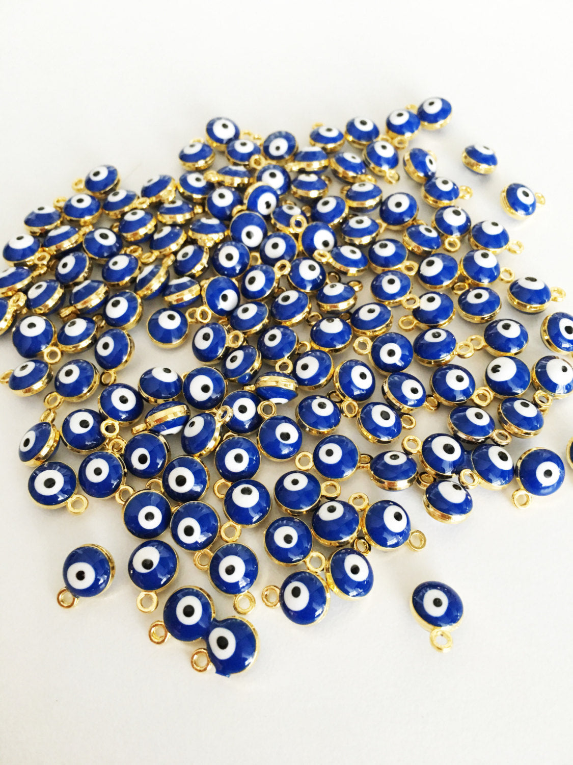 10 pcs gold plated evil eye charm set featuring blue Turkish evil eye beads, perfect for jewelry making.