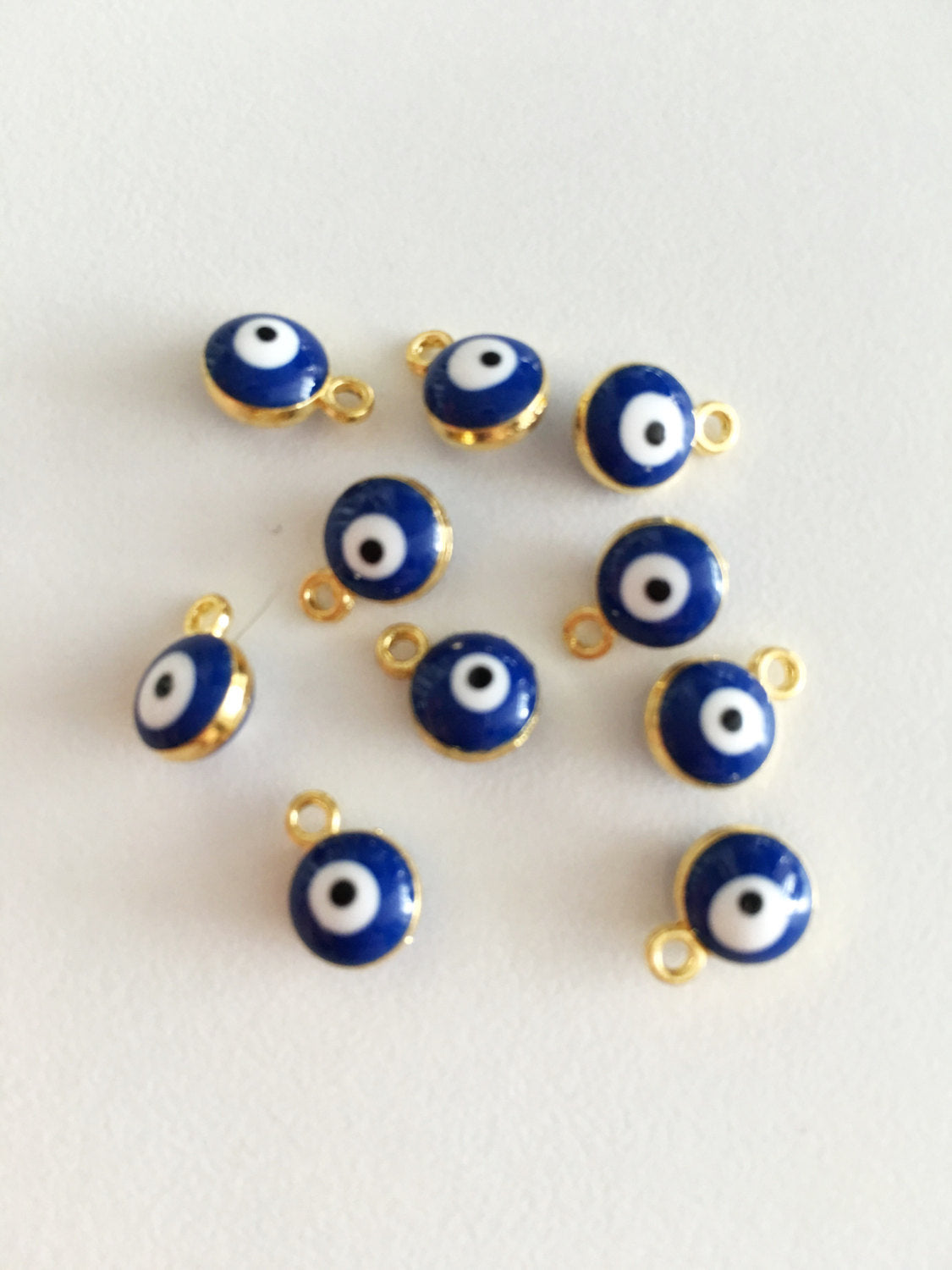 10 pcs gold plated evil eye charm set featuring blue Turkish evil eye beads, perfect for jewelry making.