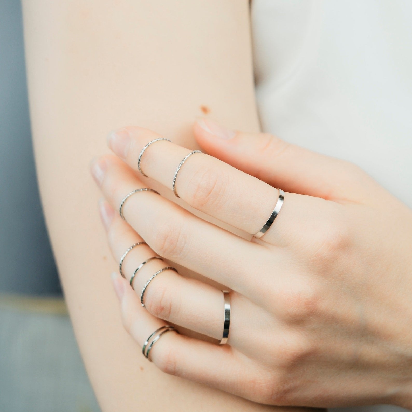 10 Piece Slim Silver Gold Stackable Bohemian Midi Tribal Beach Ring set displayed elegantly, showcasing various designs in silver and gold.