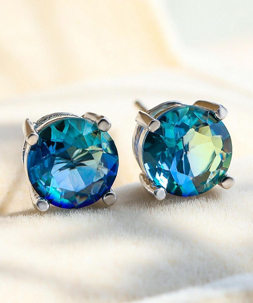 Elegant 1.25ct round cut aquamarine stud earrings with bi-color crystals set in 18k gold, showcasing Italian craftsmanship.