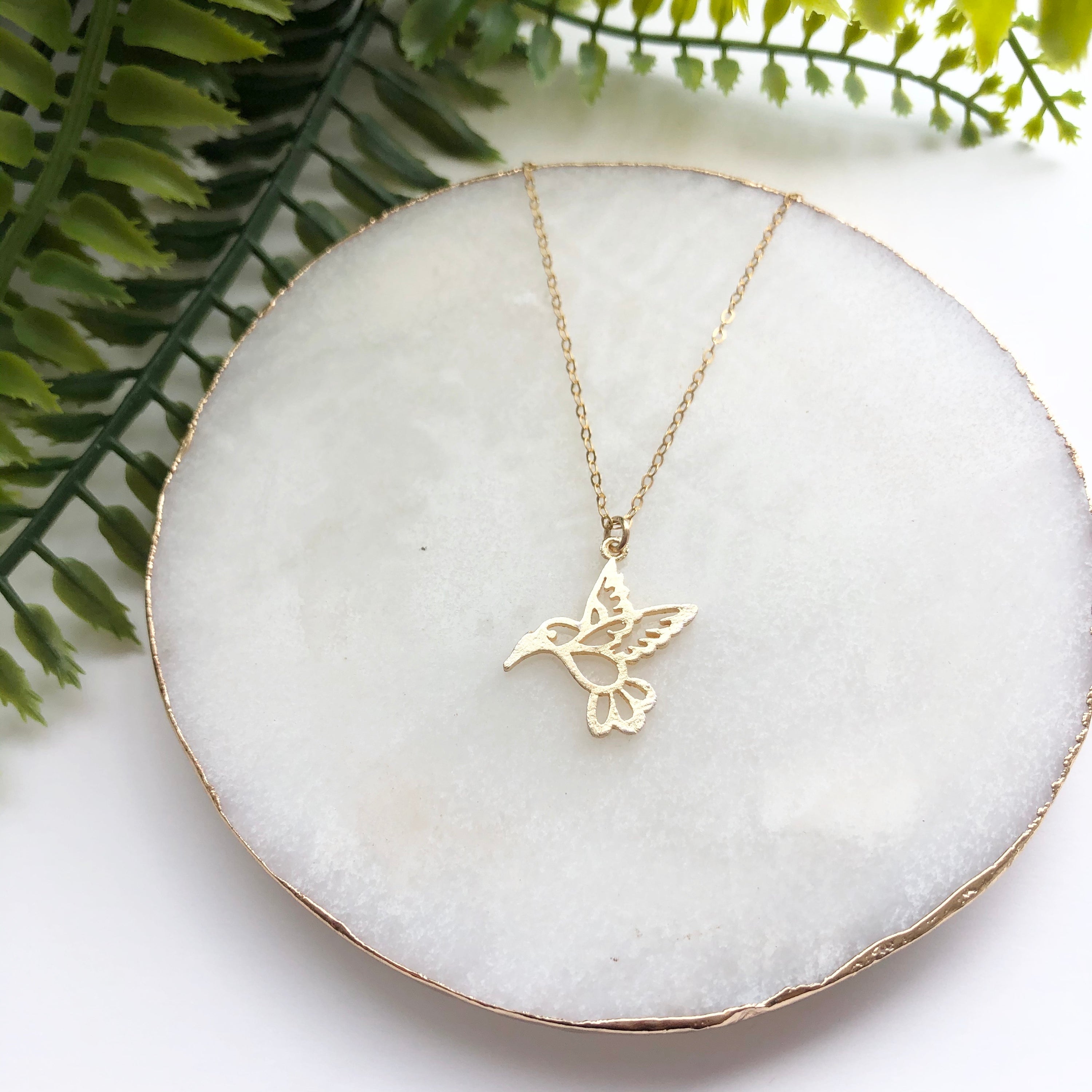 14K Gold Filled Bird of Paradise Necklace featuring a cut-out Hummingbird charm on a cable chain, symbolizing joy and good luck.