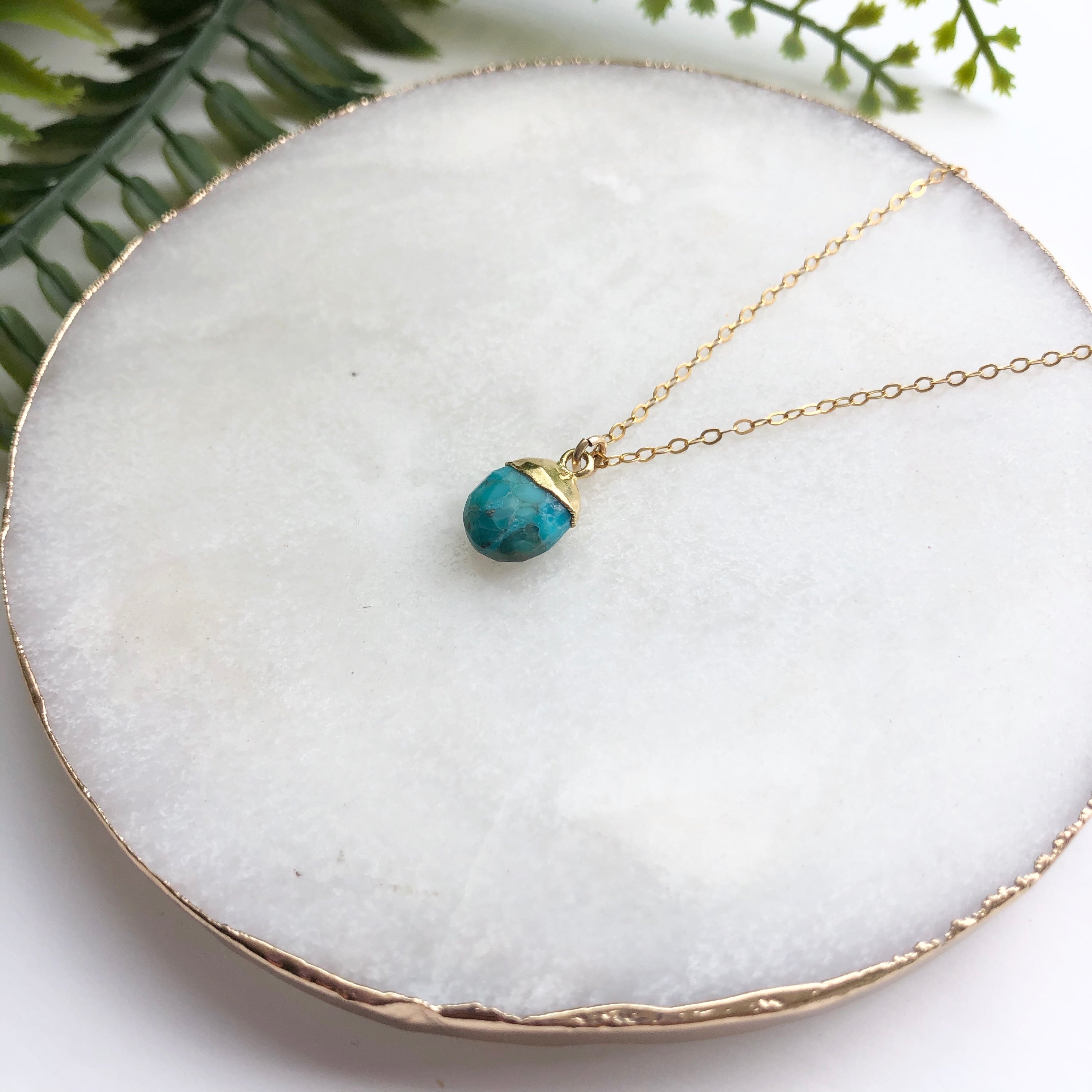 A delicate 14K gold filled necklace featuring a hand-cut Snow Pea pendant, elegantly displayed on a soft background.