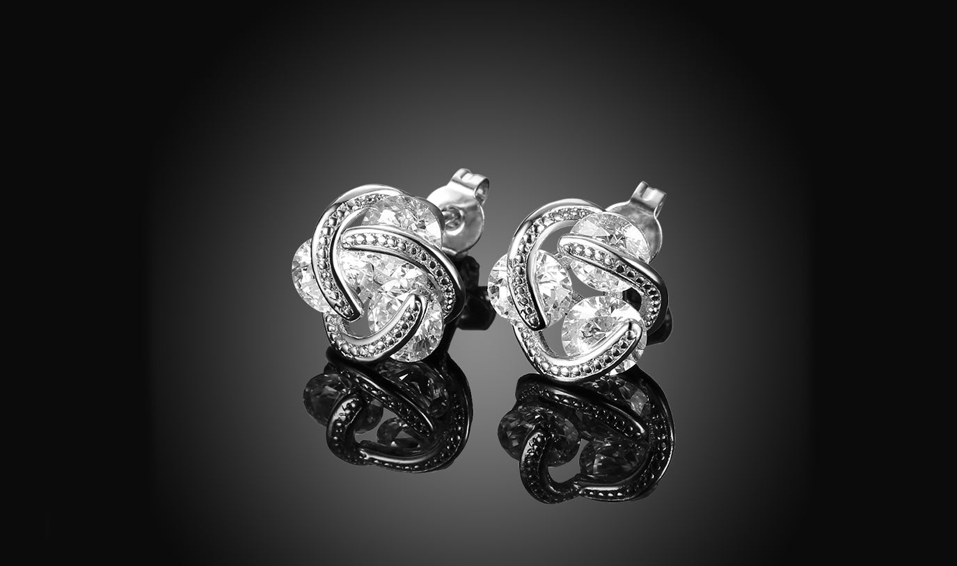 Elegant 14K Gold Plating Twisted 3-Stone Stud Earrings in gold, showcasing their intricate design and sparkling stones.