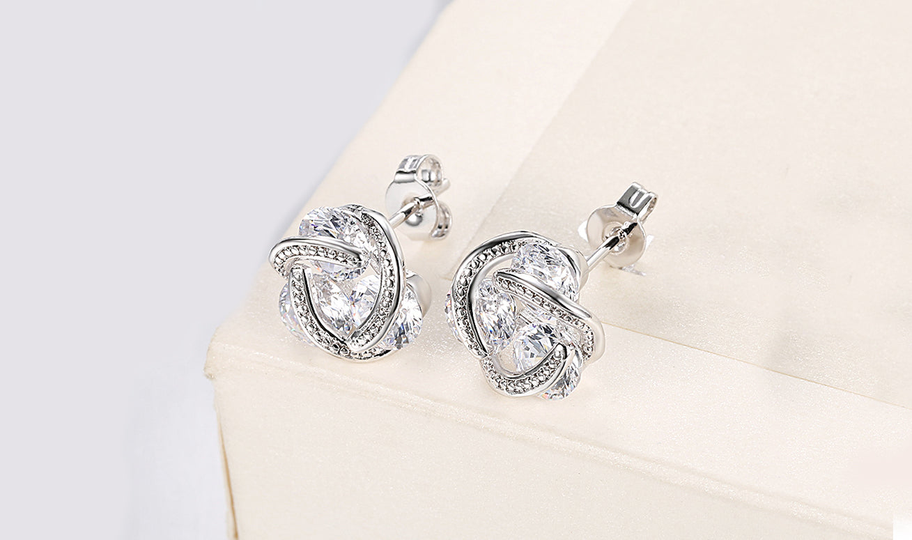 Elegant 14K Gold Plating Twisted 3-Stone Stud Earrings in gold, showcasing their intricate design and sparkling stones.