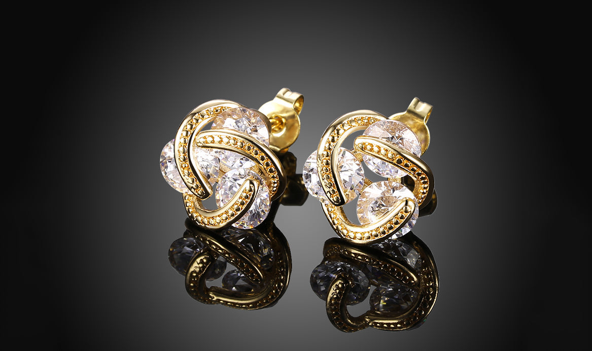 Elegant 14K Gold Plating Twisted 3-Stone Stud Earrings in gold, showcasing their intricate design and sparkling stones.