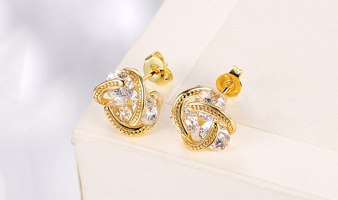 Elegant 14K Gold Plating Twisted 3-Stone Stud Earrings in gold, showcasing their intricate design and sparkling stones.