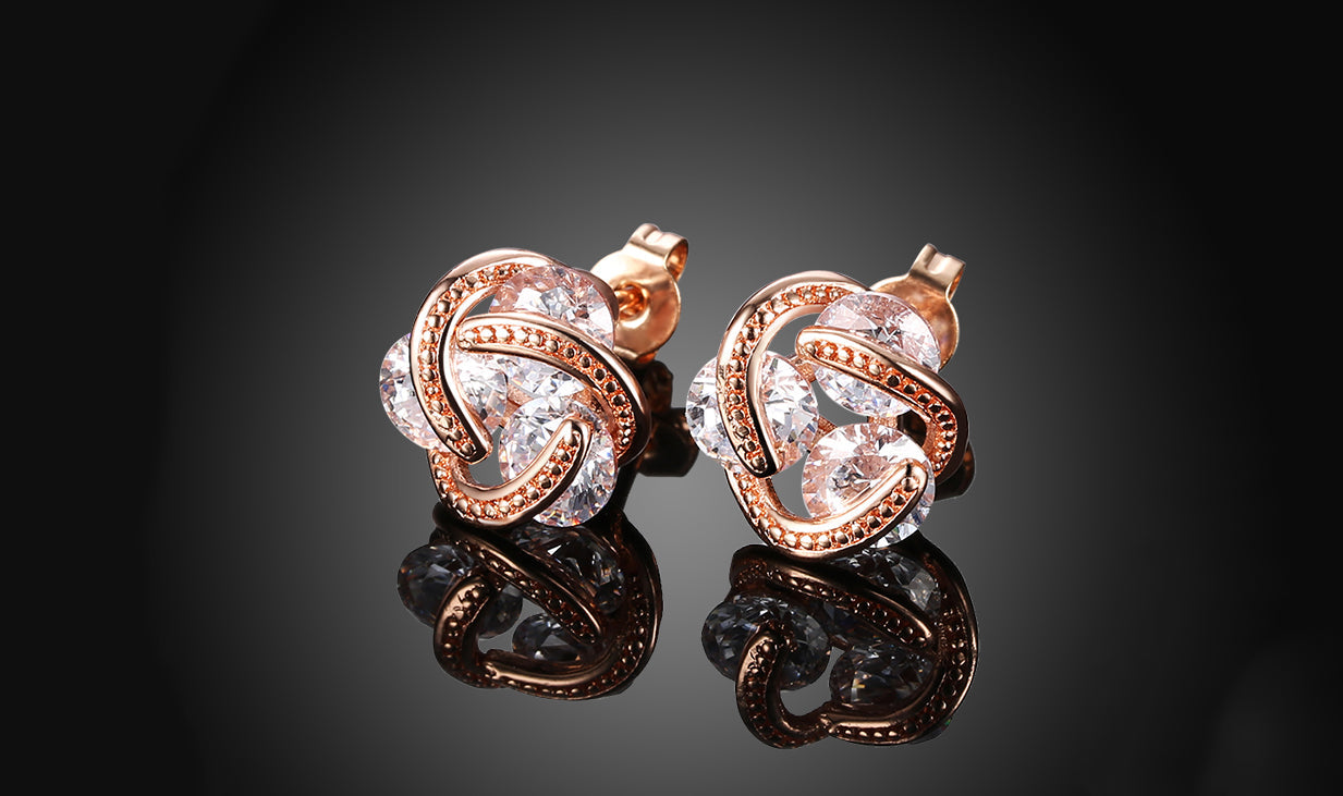 Elegant 14K Gold Plating Twisted 3-Stone Stud Earrings in gold, showcasing their intricate design and sparkling stones.