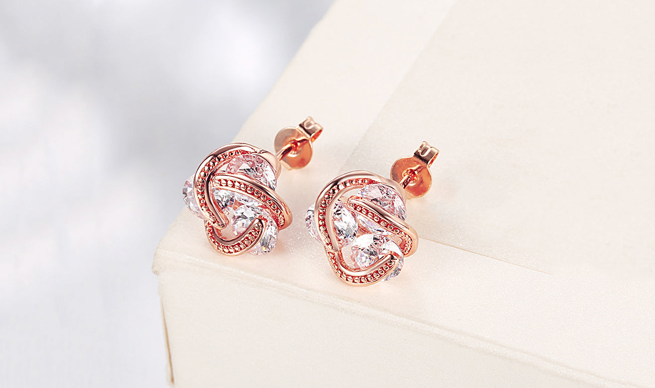 Elegant 14K Gold Plating Twisted 3-Stone Stud Earrings in gold, showcasing their intricate design and sparkling stones.