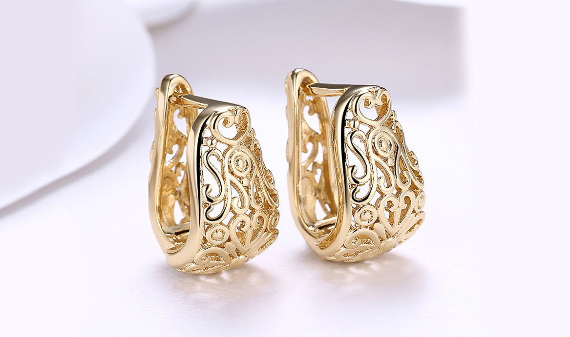 Elegant 14K gold plated filigree laser cut clip-on earrings, showcasing intricate design and craftsmanship.