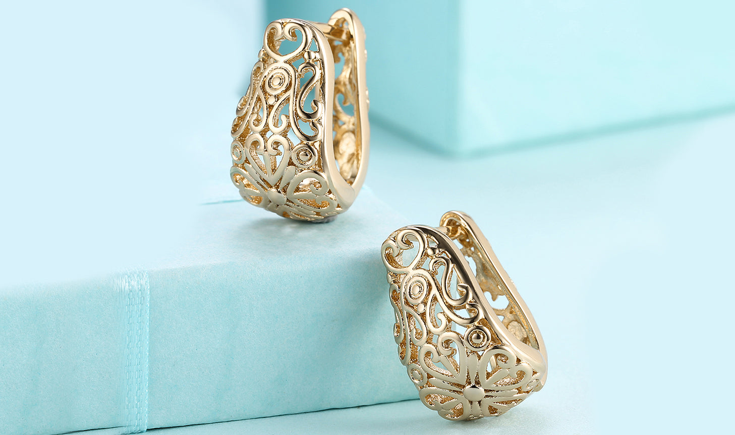 Elegant 14K gold plated filigree laser cut clip-on earrings, showcasing intricate design and craftsmanship.