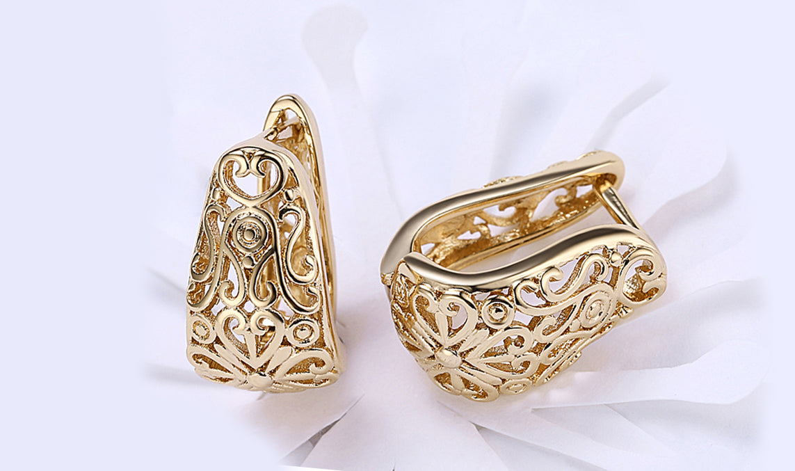 Elegant 14K gold plated filigree laser cut clip-on earrings, showcasing intricate design and craftsmanship.