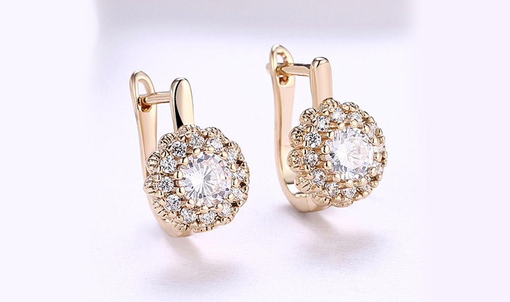 Elegant 14K gold plated huggie earrings featuring a floral design with white pav'e Austrian stones, perfect for any occasion.