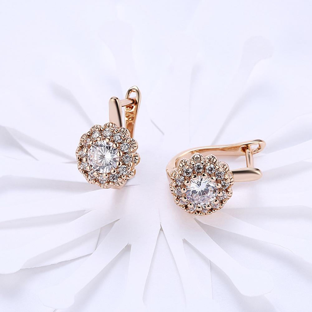 Elegant 14K gold plated huggie earrings featuring a floral design with white pav'e Austrian stones, perfect for any occasion.