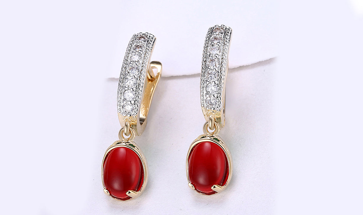 Elegant 14K gold plated clip-on earrings featuring red larimar stones, perfect for any occasion.