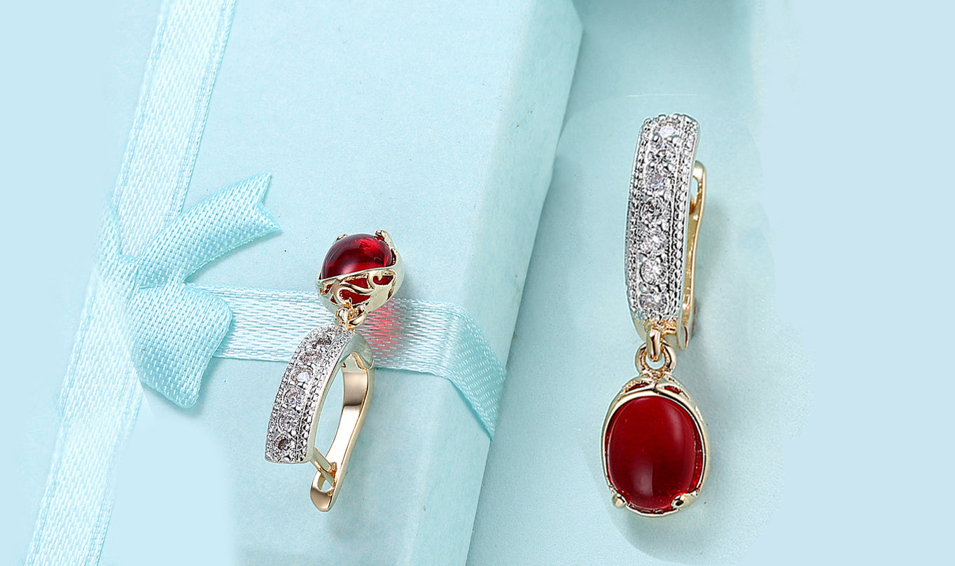 Elegant 14K gold plated clip-on earrings featuring red larimar stones, perfect for any occasion.