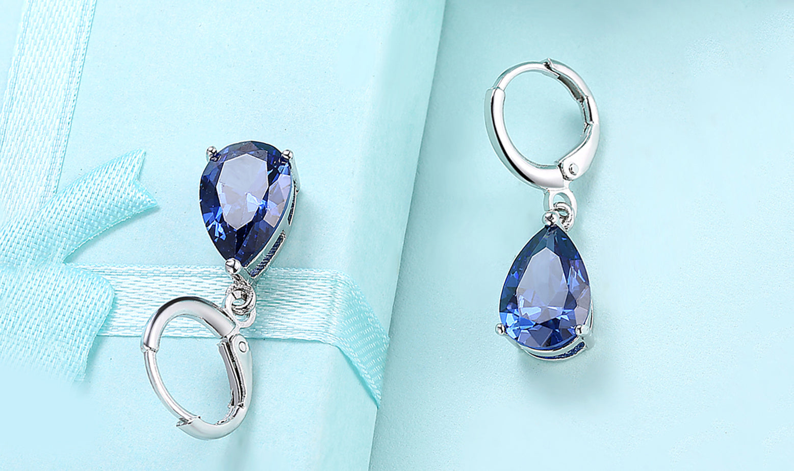 Elegant 14K Gold Plating Sleek Gemstone Pear Cut Drop Earrings in Sapphire, Amethyst, and White Sapphire options, showcasing their luxurious design.