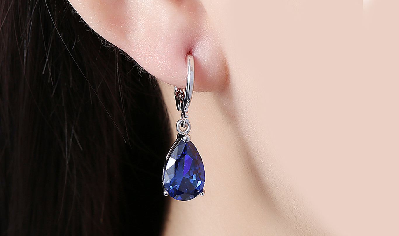 Elegant 14K Gold Plating Sleek Gemstone Pear Cut Drop Earrings in Sapphire, Amethyst, and White Sapphire options, showcasing their luxurious design.