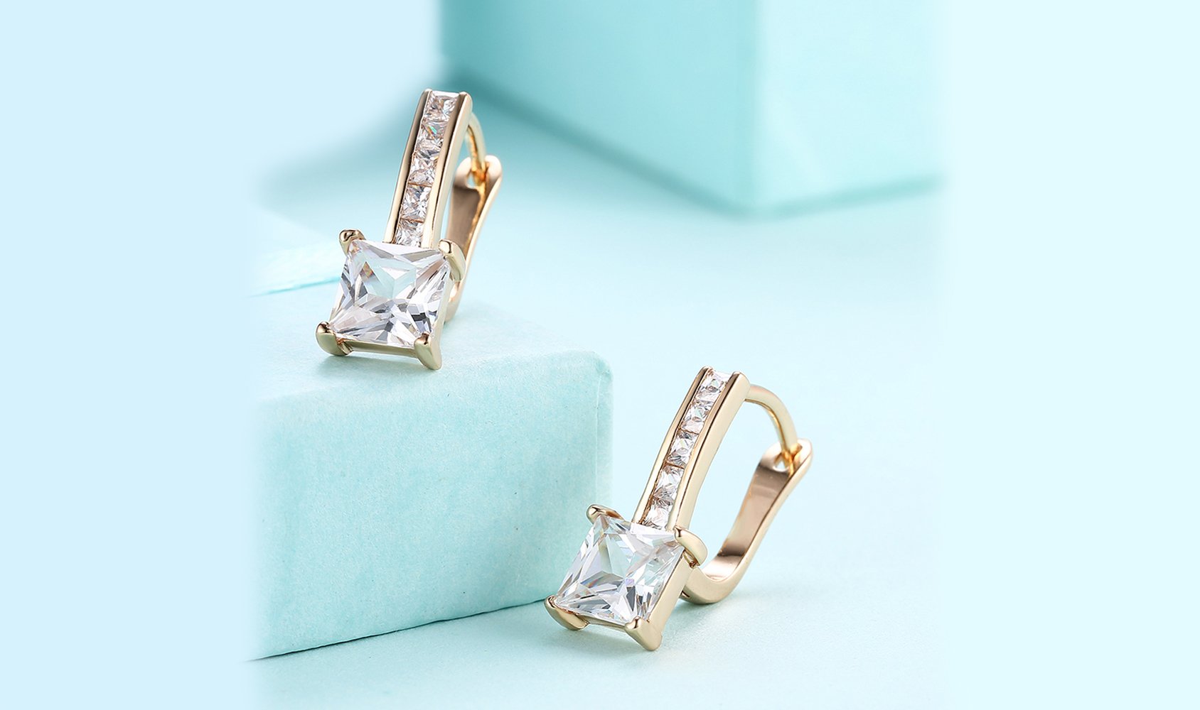 Elegant 14K gold plated lever back earrings featuring white Austrian elements, showcasing a sleek and classic design.