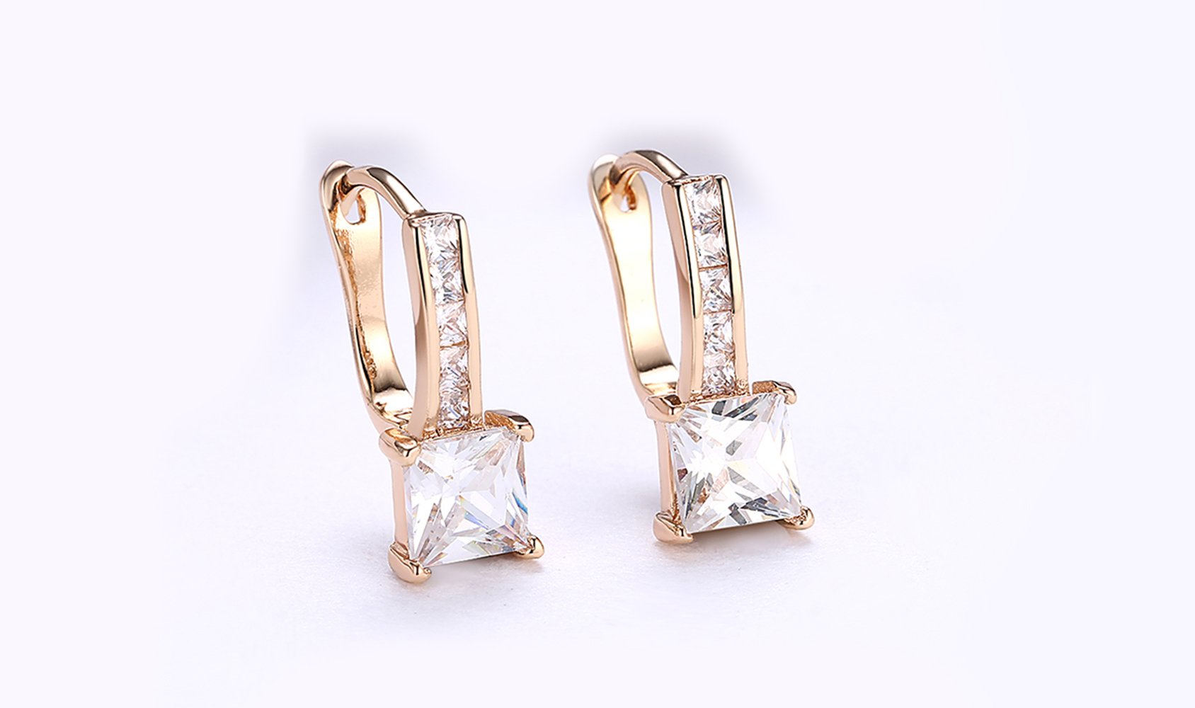 Elegant 14K gold plated lever back earrings featuring white Austrian elements, showcasing a sleek and classic design.