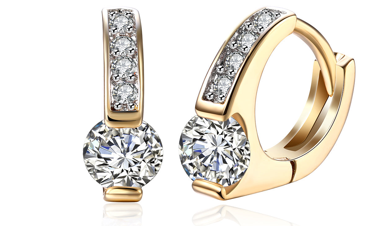 Elegant 14K gold plated clip-on earrings featuring white sapphire stones in a unique harp shape design.