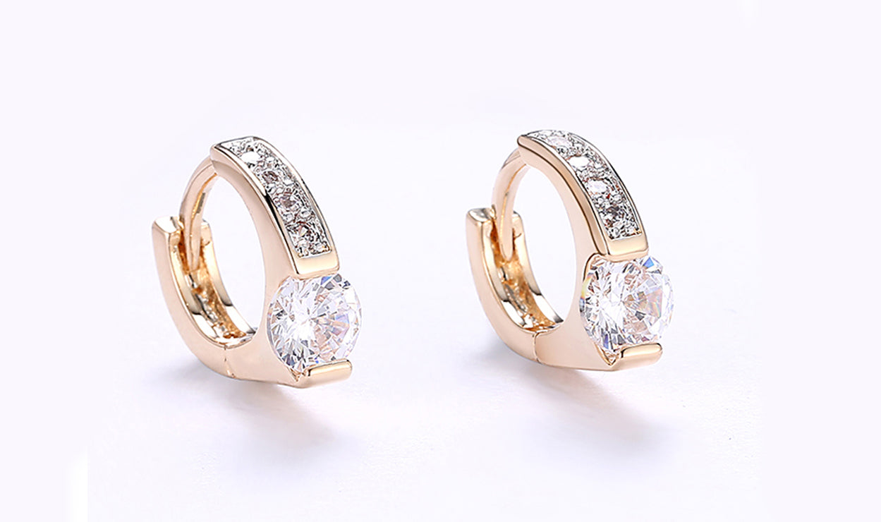 Elegant 14K gold plated clip-on earrings featuring white sapphire stones in a unique harp shape design.