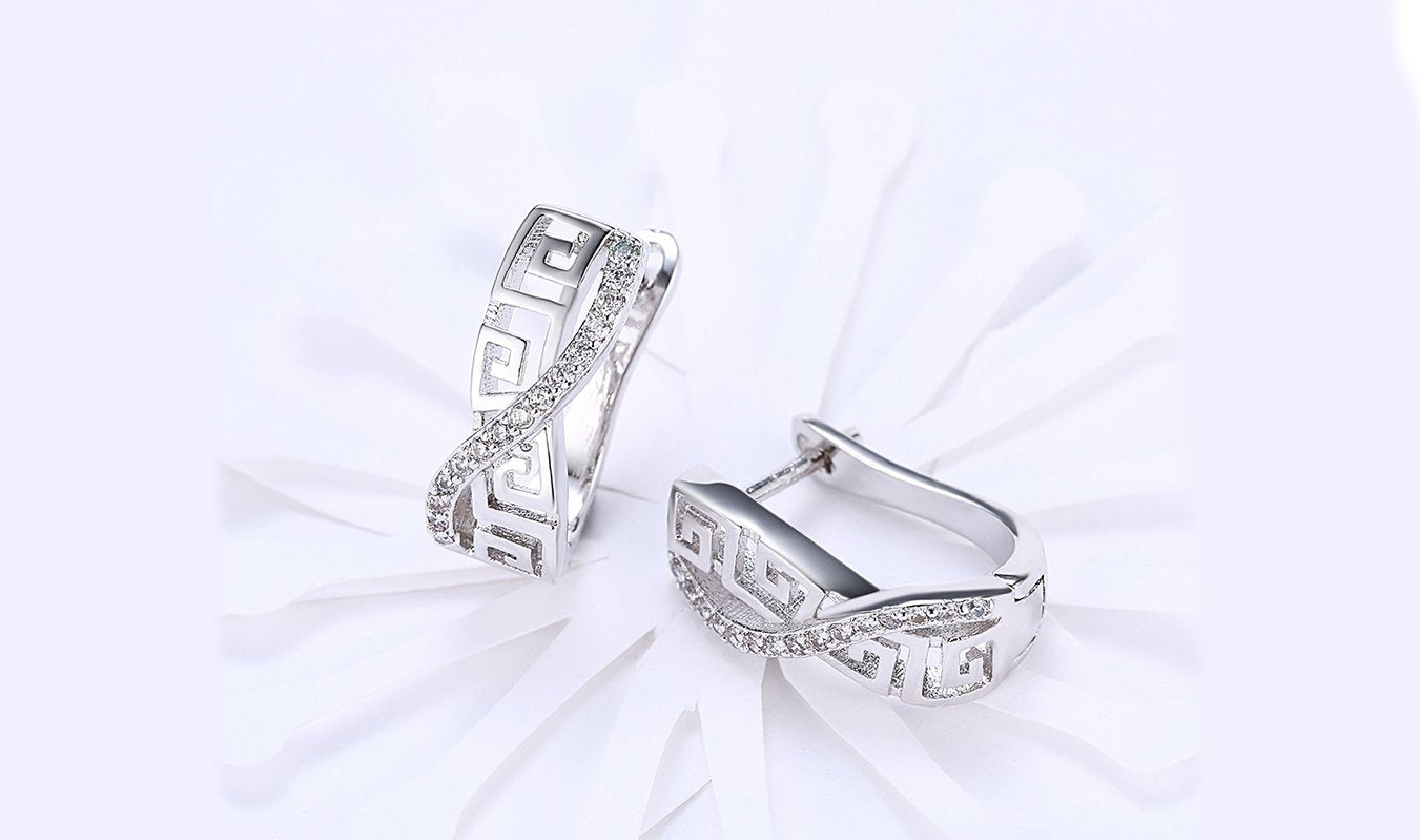 Elegant 14K white gold plated earrings featuring a Greek key design with sparkling Austrian elements.