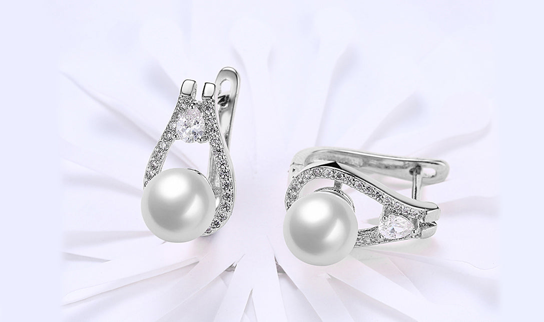 Elegant 14K white gold plated clip-on earrings featuring freshwater pearls in a pear cut design, perfect for any occasion.