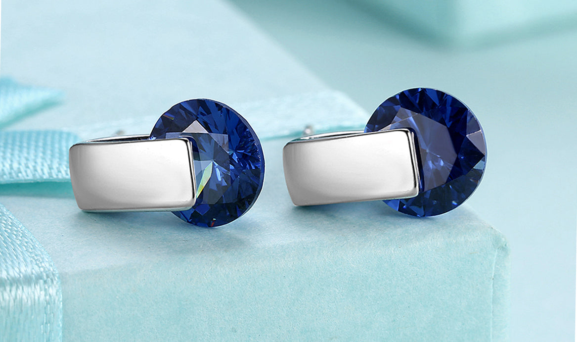 Elegant 14K white gold plated earrings featuring a stunning blue sapphire stone, perfect for any occasion.